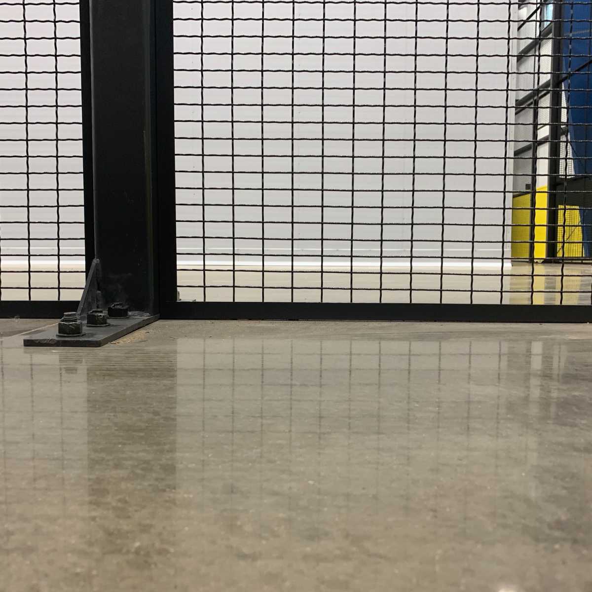840 black mesh panel bolted into concrete floor