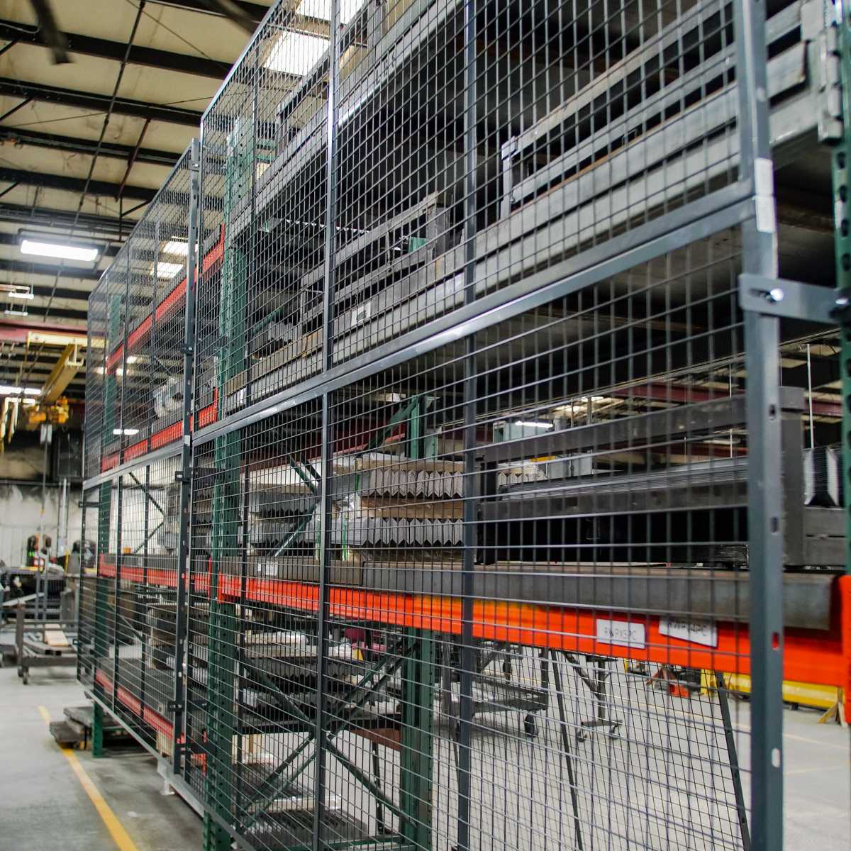 grey wire mesh pallet rack attached to back of shelving unit